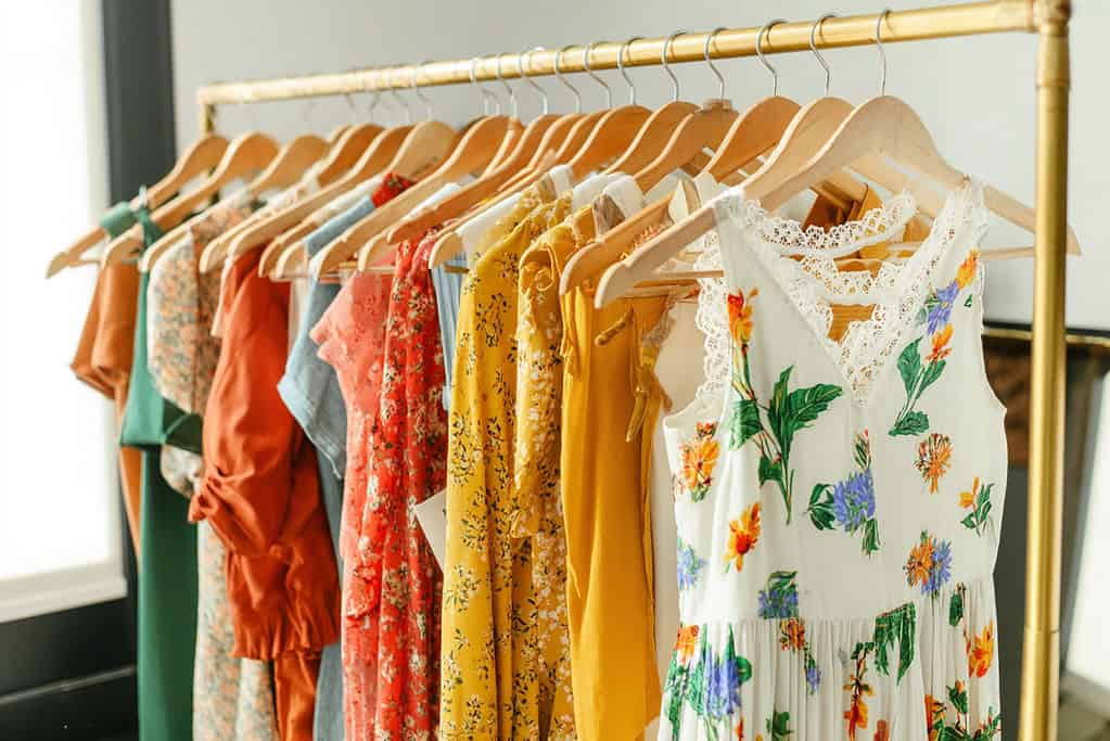 a well-organized clothing rack in a stylish boutique or modern wardrobe setting