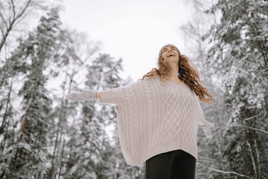 A happy woman in a forest in winter