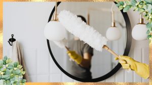 a person cleaning the mirror