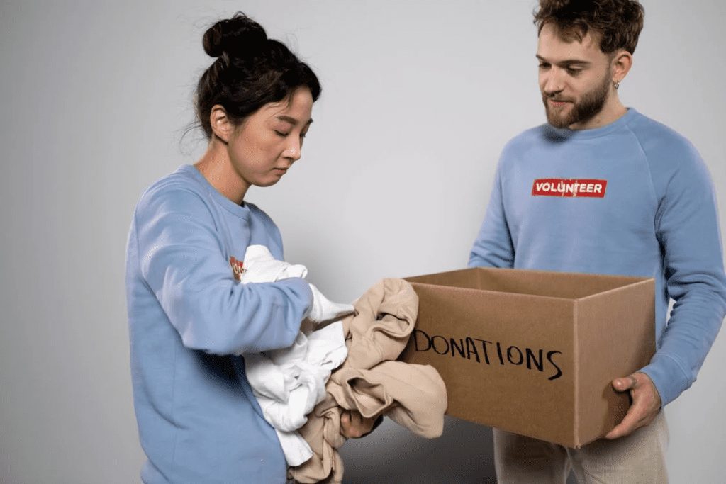 A woman holding clothes for donations