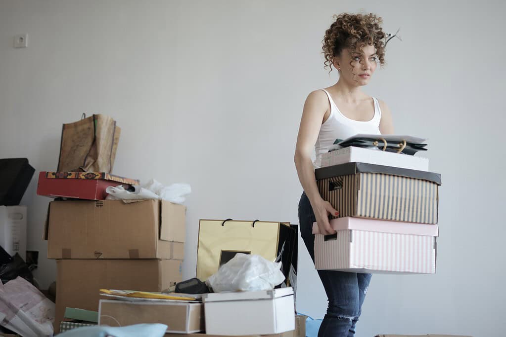 a woman carrying boxes 