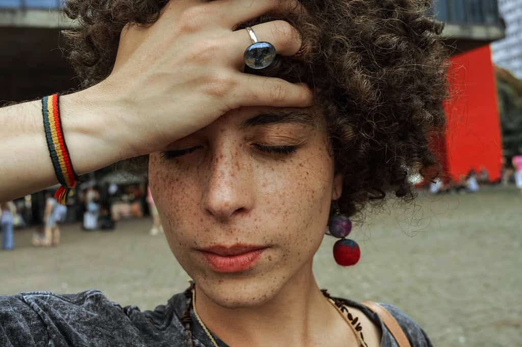 a woman holding her forehead