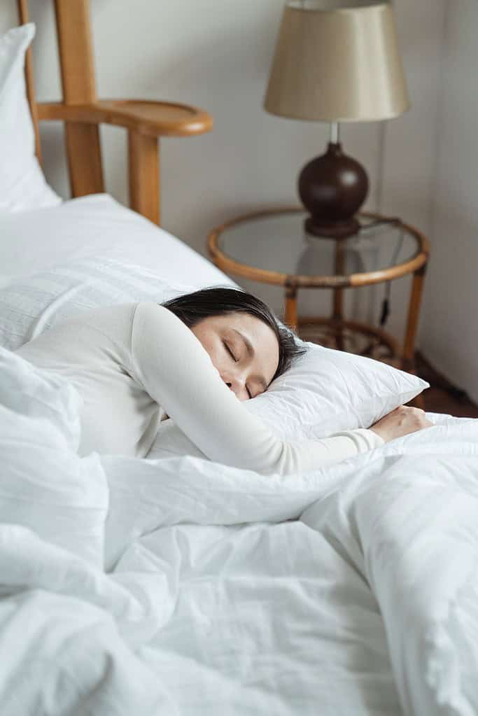 a woman sleeping in her bed