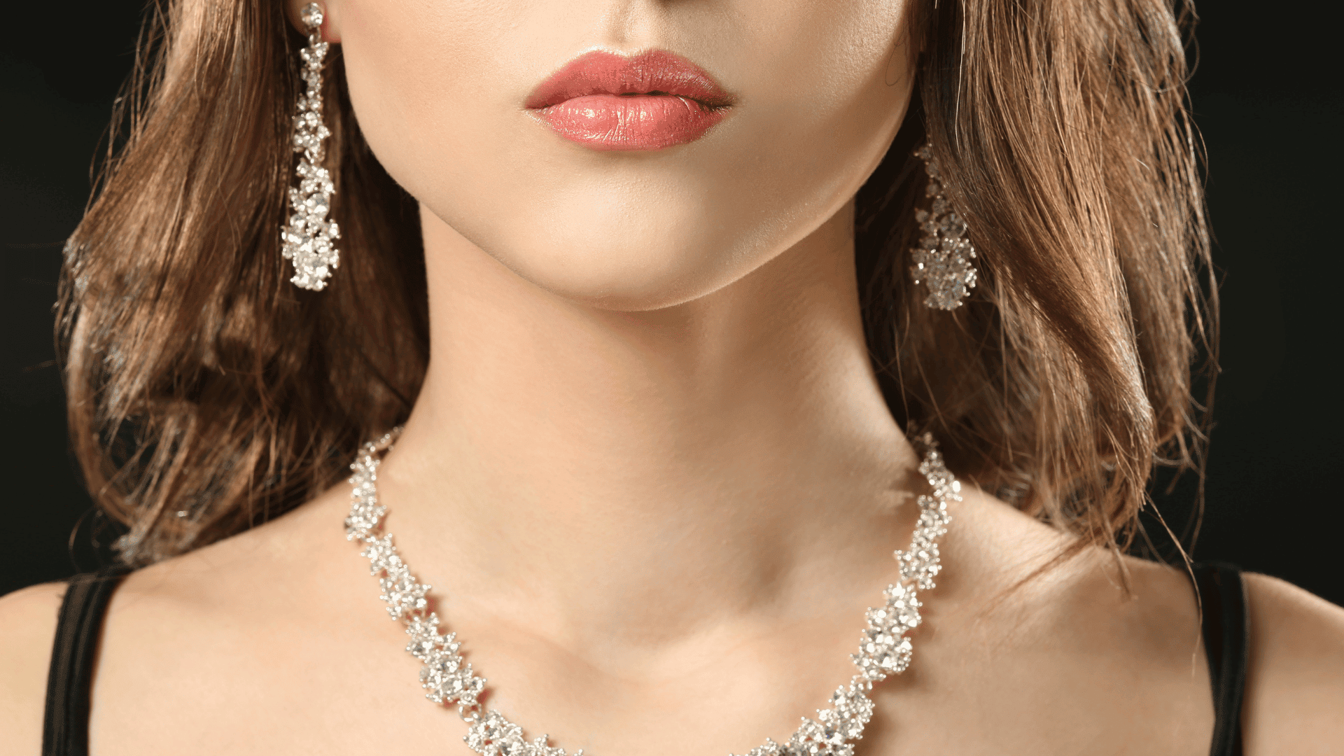 Woman with Elegant Jewelry on Dark Background Woman with Elegant Jewelry on Dark Background