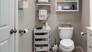 An organized bathroom with a white door