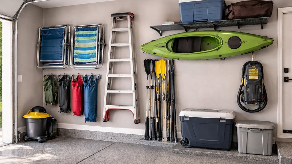 Outdoor gears and tools hooked in the wall of a garage