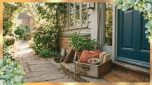 A clean garden porch with a teal door, a wooden crate and wicker basket filled with belongings ready for donation, surrounded by lush green plants