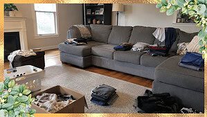 A lived-in living room mid-declutter with belongings sorted into small piles and a half-full donation box, showing how to decide what to keep when decluttering