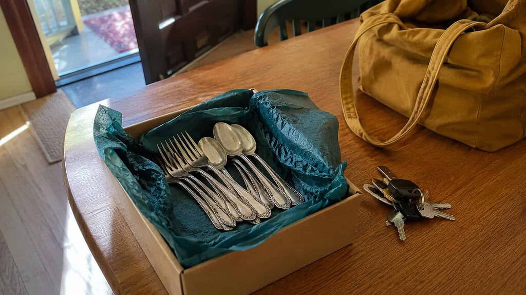 A set of inherited silver flatware packed in a tissue-lined box to give to someone who will use it