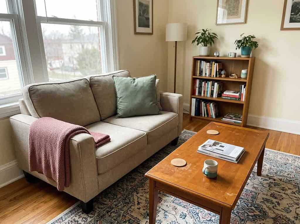 A tidy, lived-in shared living room kept clear by agreement, the common space both spouses keep presentable