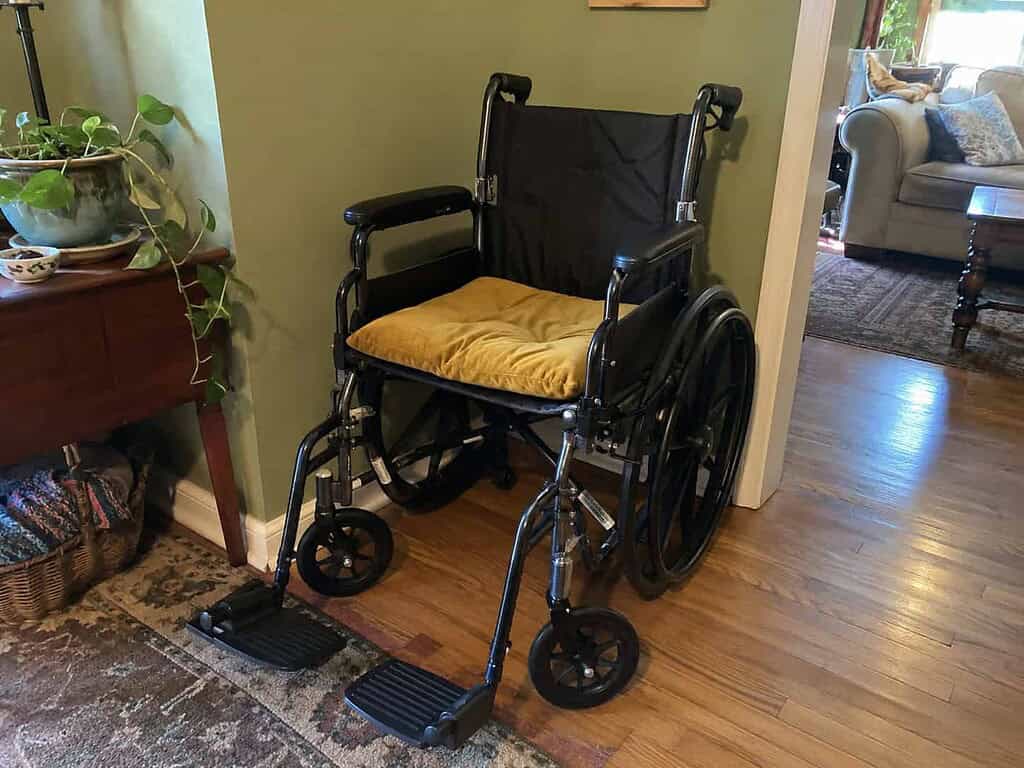 A clean folding manual wheelchair, wiped down and complete, ready to be donated
