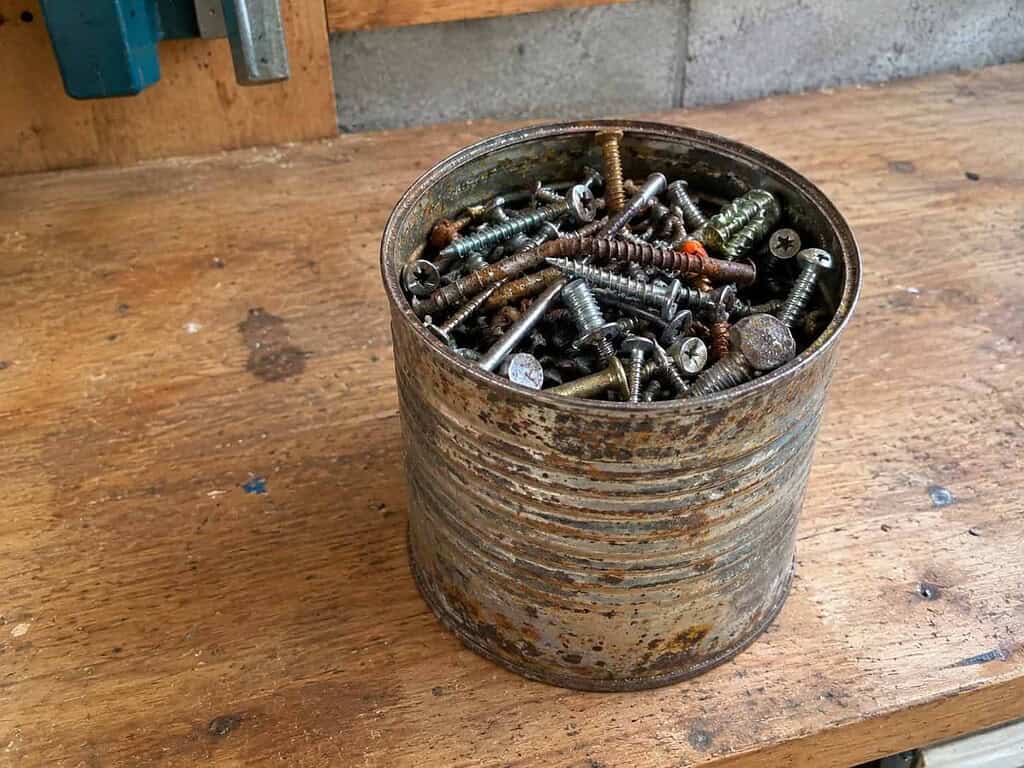 An old coffee can full of screws on a workbench, the small thing behind the fight I couldn't win