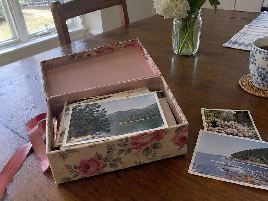 One open keepsake box with a few old photographs being sorted, the sentimental spaces saved for last