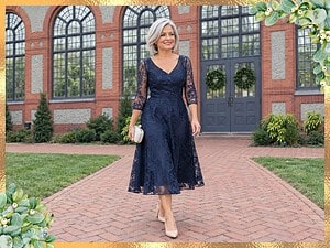 Mother of the bride in a navy lace dress walking past the Walled Garden Conservatory at the Biltmore Estate