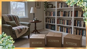 Small reading room with a chair, white bookshelves and three boxes of books labeled for the library sale, Little Free Library and nursing home