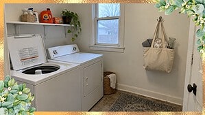 Canvas donation tote filled with a sweater, sheets and a vase hanging on a hook in a laundry room